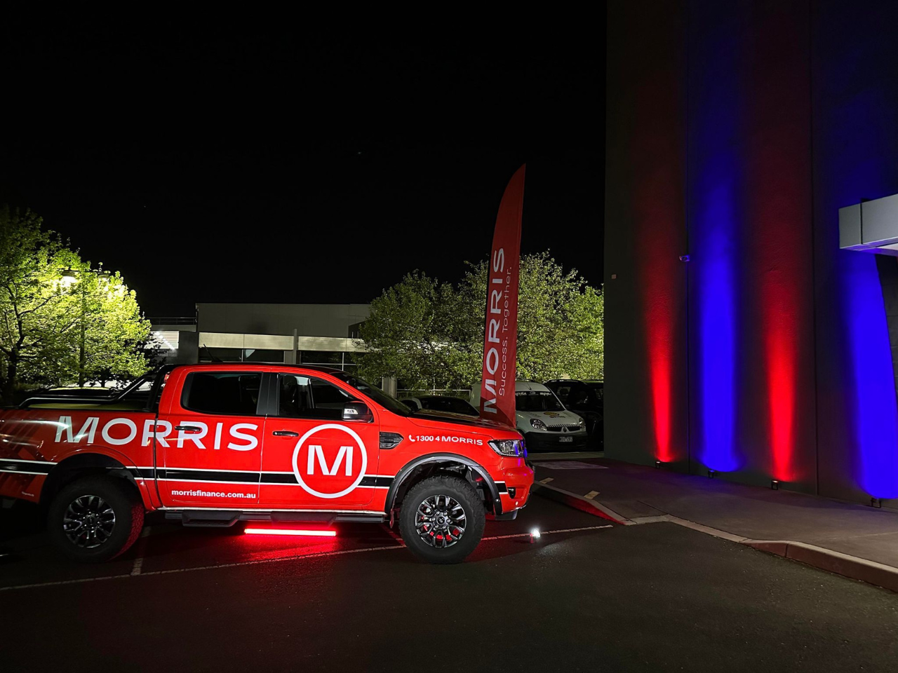 Image of vehicle lit up at night with lights