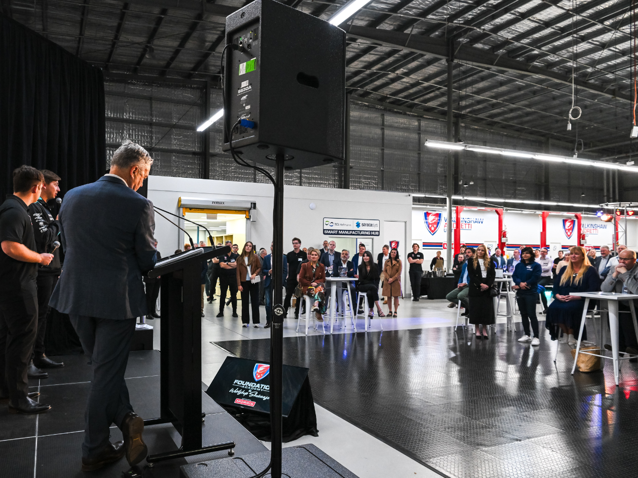 Image of people watching a presentation on stage